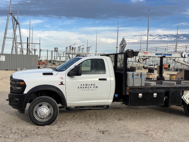 A truck sitting in front of a power grid