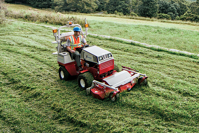 A commercial lawnmower cutting grass